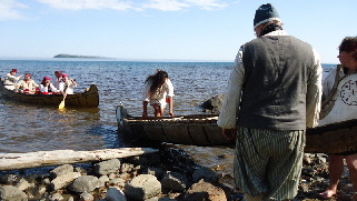 Voyageurs land canoes